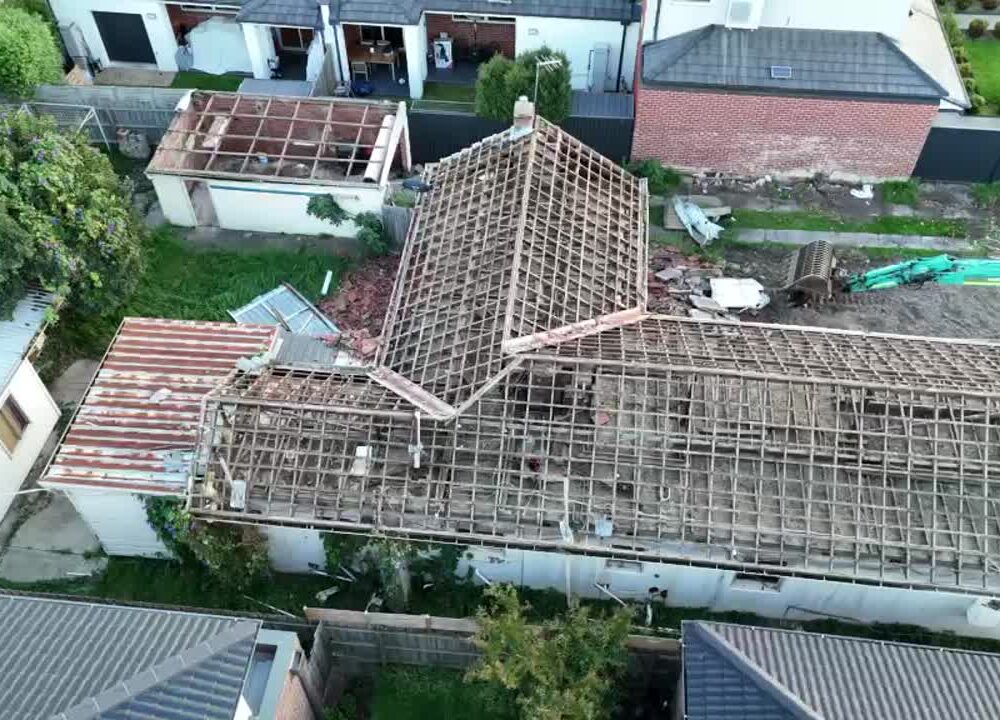 Aerial drone view of a heritage Tudor home undergoing partial demolition in inner Melbourne