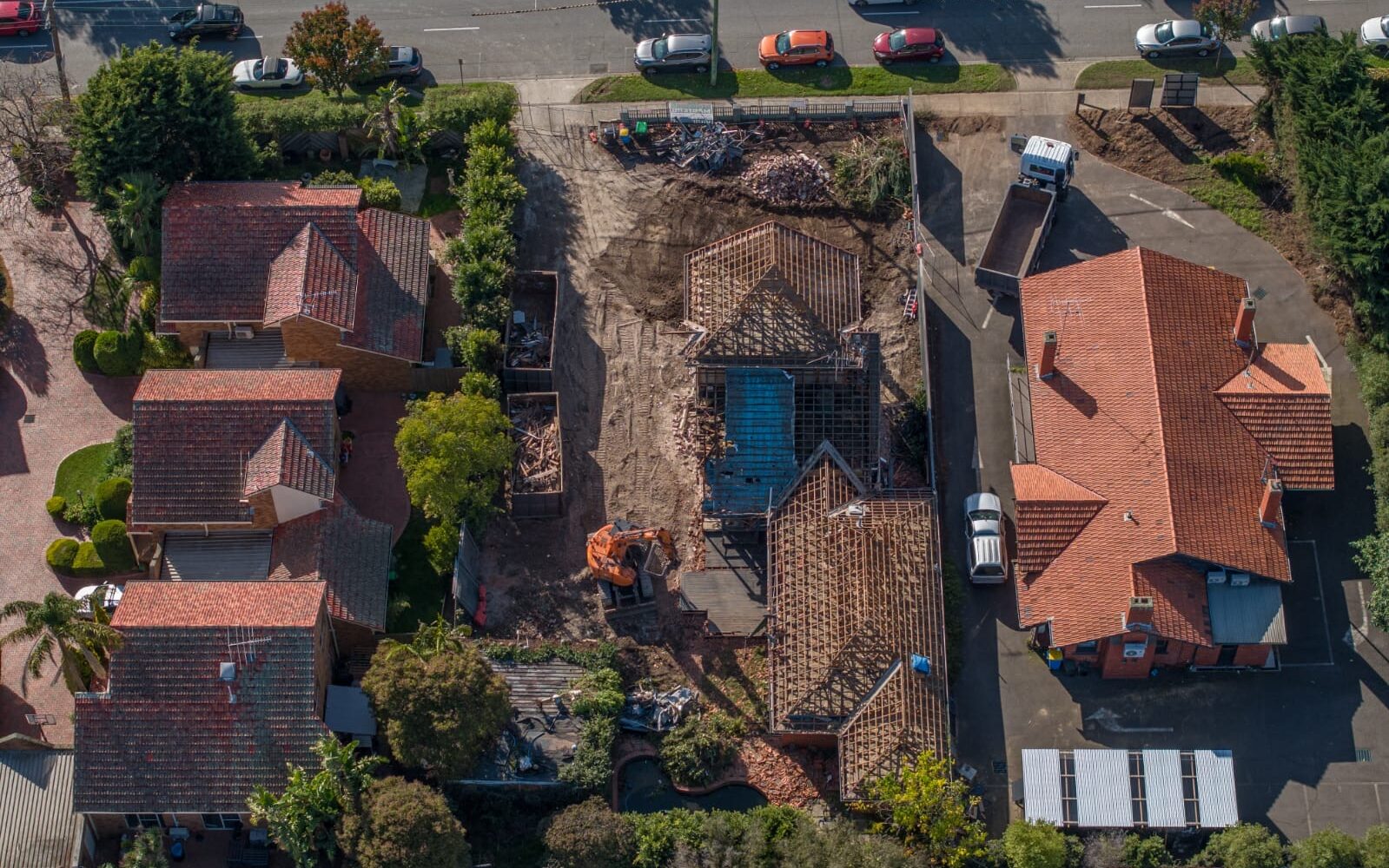 Aerial drone view of a partial demolition project between two existing residential properties