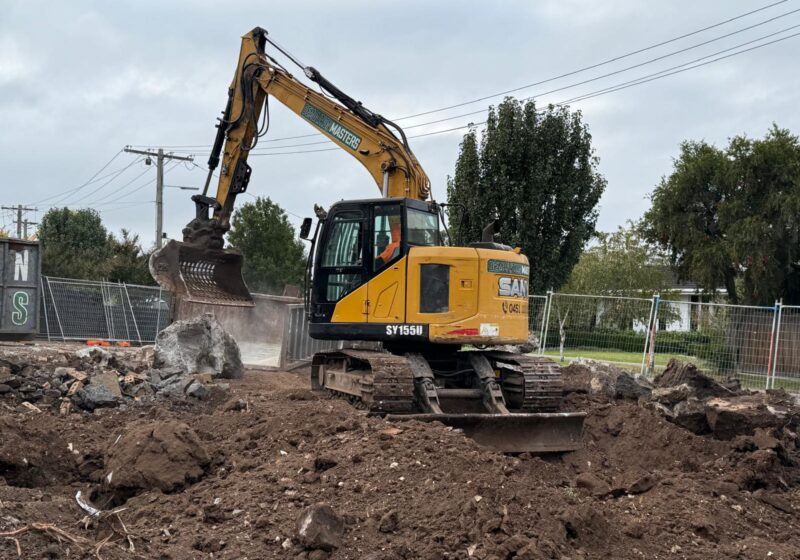 Yellow Demolition Masters excavator on a Melbourne earthworks site with cleared earth